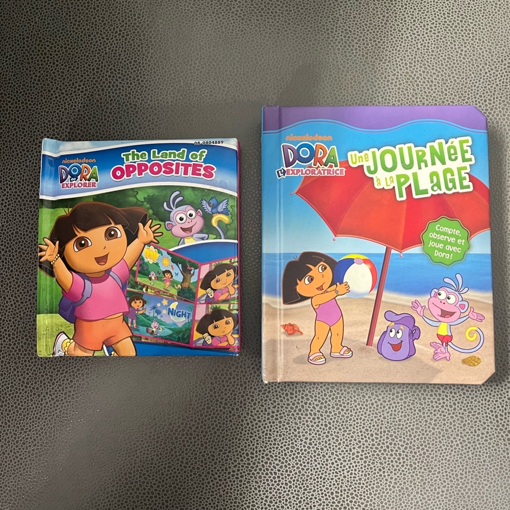 Dora books (1 French) both new